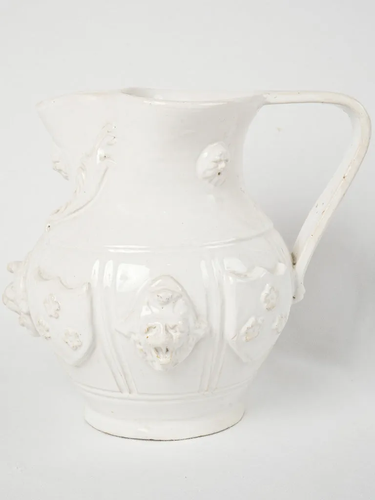 Large Émile Tessier pitcher w/ masks & coat of arms 9"